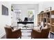 Home office has natural light, shelving, and comfortable seating for a productive workspace at 6701 Prelude Dr, Atlanta, GA 30328