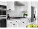 Modern kitchen boasts stainless steel appliances, white cabinetry, subway tile backsplash, and sleek countertops at 6701 Prelude Dr, Atlanta, GA 30328
