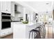 Modern white kitchen featuring stainless steel appliances and a breakfast bar at 6701 Prelude Dr, Atlanta, GA 30328