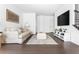 Bright living room features hardwood floors, a comfortable sofa, and modern entertainment center at 6701 Prelude Dr, Atlanta, GA 30328