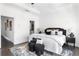 Bright main bedroom featuring modern décor, dark wood floors, and a tray ceiling at 6701 Prelude Dr, Atlanta, GA 30328