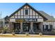 The Food Terminal restaurant exterior features stone columns and outdoor seating with an inviting look at 6701 Prelude Dr, Atlanta, GA 30328
