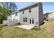View of backyard with a white fence, patio, and grassy area; backs to a treeline at 1180 Cades Walk, Lawrenceville, GA 30045
