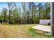 Spacious backyard featuring an expanse of lawn, bordered by a fence and a wooded area at 1180 Cades Walk, Lawrenceville, GA 30045