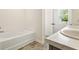 Bathroom with a soaking tub and a double vanity with a marble countertop at 1180 Cades Walk, Lawrenceville, GA 30045