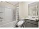 Bathroom features a bathtub-shower combo and a vanity with a light-colored countertop at 1180 Cades Walk, Lawrenceville, GA 30045