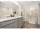 Bathroom with a double vanity and a large glass enclosed shower with tiled walls at 1180 Cades Walk, Lawrenceville, GA 30045