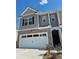 Exterior shot of a townhouse, showcasing a brick and siding facade, and an attached garage at 1180 Cades Walk, Lawrenceville, GA 30045