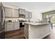 Modern kitchen with granite countertops, stainless steel appliances, and a breakfast bar at 1180 Cades Walk, Lawrenceville, GA 30045