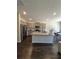 Open-concept kitchen with an island, granite countertops, and stainless steel appliances at 1180 Cades Walk, Lawrenceville, GA 30045