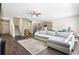 Bright living room with hardwood floors, a gray sectional sofa, and an open layout at 1180 Cades Walk, Lawrenceville, GA 30045