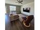Cozy living room featuring hardwood floors, a comfortable sofa, and a view of the backyard at 1180 Cades Walk, Lawrenceville, GA 30045