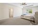 Spacious main bedroom with plush carpeting and views from its large window at 1180 Cades Walk, Lawrenceville, GA 30045