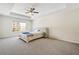 Spacious main bedroom with plush carpeting and a large window, perfect for relaxation at 1180 Cades Walk, Lawrenceville, GA 30045
