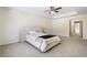 Spacious main bedroom with a tray ceiling, ceiling fan, and neutral carpeting at 1180 Cades Walk, Lawrenceville, GA 30045