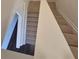Overhead view of a carpeted staircase with a white handrail, adjacent to tile flooring at 1180 Cades Walk, Lawrenceville, GA 30045
