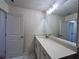 Bright bathroom with white vanity, quartz countertop, and large mirror at 1812 Emory Ln # 93, Conyers, GA 30013