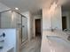 Bright bathroom features a glass enclosed shower, double sink vanity, and attractive marble tile flooring at 1812 Emory Ln # 93, Conyers, GA 30013