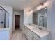 Bright bathroom with shower, double sink vanity, white cabinets, quartz countertops, and a large mirror at 1812 Emory Ln # 93, Conyers, GA 30013