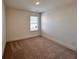 Bedroom features neutral walls, carpet, one window, and white trim at 1812 Emory Ln # 93, Conyers, GA 30013