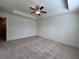 Bedroom featuring a tray ceiling, neutral walls, and an open doorway at 1812 Emory Ln # 93, Conyers, GA 30013