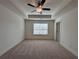 Carpeted bedroom with tray ceiling and a bright window overlooking the yard at 1812 Emory Ln # 93, Conyers, GA 30013