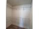 Bright, walk-in closet featuring white wire shelving for organized storage at 1812 Emory Ln # 93, Conyers, GA 30013