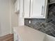 Close-up shot of the kitchen's countertops and stylish backsplash at 1812 Emory Ln # 93, Conyers, GA 30013