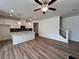Open living area with combined kitchen, ceiling fan and staircase at 1812 Emory Ln # 93, Conyers, GA 30013