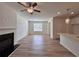 Bright living room featuring fireplace, ceiling fan and wood-look flooring at 1812 Emory Ln # 93, Conyers, GA 30013