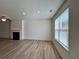 Bright living room area with large windows and a cozy fireplace at 1812 Emory Ln # 93, Conyers, GA 30013