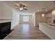 Living room with a fireplace, ceiling fan, and a view of the kitchen island at 1812 Emory Ln # 93, Conyers, GA 30013