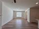 Bright, open-concept living room featuring wood-look floors and a large window at 1812 Emory Ln # 93, Conyers, GA 30013