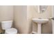 Powder room features a white toilet and pedestal sink with a white faucet at 2134 Shropshire Se Ln, Atlanta, GA 30316