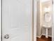 Powder room features a pedestal sink, oval mirror, and decorative lighting at 2134 Shropshire Se Ln, Atlanta, GA 30316