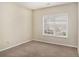 Bedroom with neutral walls, carpeted floor, and a window with blinds at 2134 Shropshire Se Ln, Atlanta, GA 30316