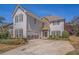 Charming two-story home with stone accents, red shutters, a two-car garage, and a well-manicured front yard at 2134 Shropshire Se Ln, Atlanta, GA 30316