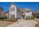 Inviting two-story home with red shutters, manicured landscaping, a stone facade, and a spacious driveway at 2134 Shropshire Se Ln, Atlanta, GA 30316