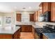View of the eat-in kitchen with wood cabinets, stainless appliances, tile backsplash and hardwood floors at 2134 Shropshire Se Ln, Atlanta, GA 30316