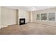 Cozy living room with a fireplace, plush carpeting, and large windows offering natural light at 2134 Shropshire Se Ln, Atlanta, GA 30316