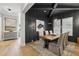 Modern dining room with a dark accent wall, a wooden table with seating for six, and striking light fixture at 2595 Apple Valley Rd, Brookhaven, GA 30319