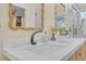 Modern bathroom featuring a stylish vanity with quartz countertop, elegant fixtures, and a wavy framed mirror at 3637 Elm St, Atlanta, GA 30354