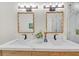 A spacious bathroom with dual sinks, wavy-framed mirrors, and modern fixtures at 3637 Elm St, Atlanta, GA 30354