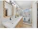 Bright bathroom featuring dual sinks, a walk-in shower, and stylish modern fixtures at 3637 Elm St, Atlanta, GA 30354