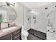 Modern bathroom featuring a frameless glass shower, elegant vanity, and stylish fixtures at 3637 Elm St, Atlanta, GA 30354