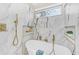 Luxurious soaking tub with marble tile surround, gold hardware, and built-in niche shelving at 3637 Elm St, Atlanta, GA 30354