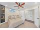 This bedroom features a ceiling fan, shelves, light carpeting, and doors to a hallway and bathroom at 3637 Elm St, Atlanta, GA 30354