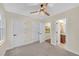 This room has a ceiling fan, neutral paint, light carpeting, and doors to a hallway and bathroom at 3637 Elm St, Atlanta, GA 30354