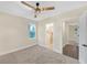 Cozy bedroom with a ceiling fan, neutral paint, light carpeting, and a view to a bathroom at 3637 Elm St, Atlanta, GA 30354
