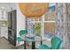 Cozy breakfast nook with glass table, stylish green chairs, a modern light fixture, and natural light from the window at 3637 Elm St, Atlanta, GA 30354